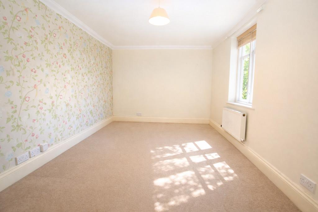 Sunlit bedroom with floral wallpaper (1)