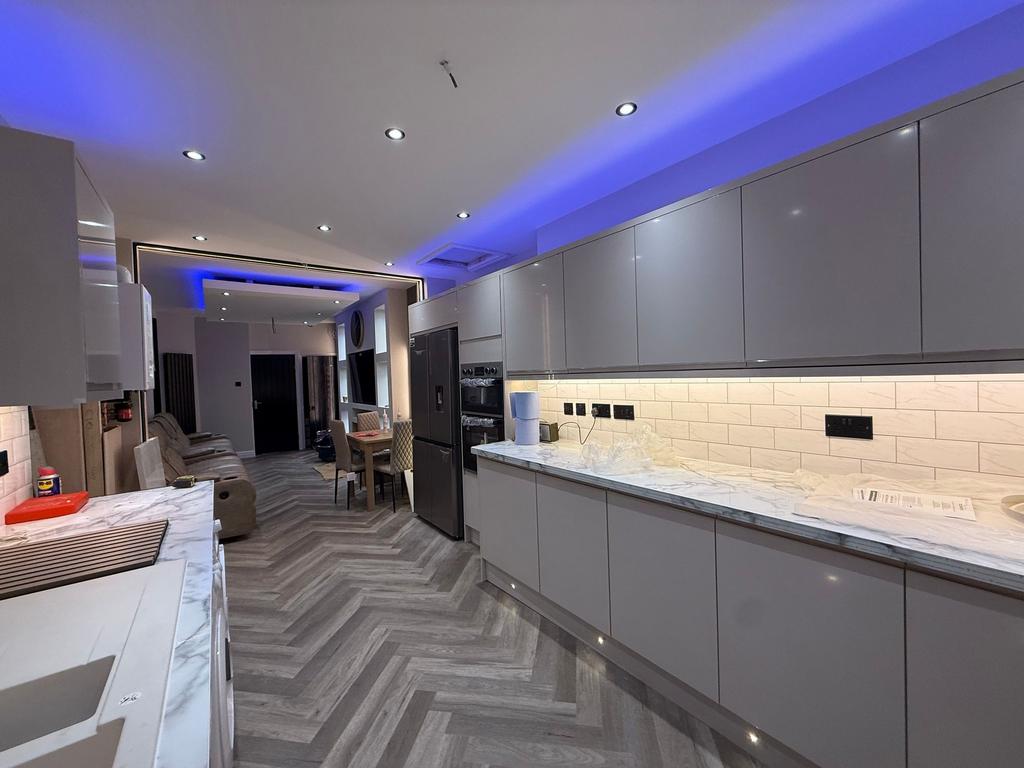 Contemporary open-plan kitchen with sleek grey ...