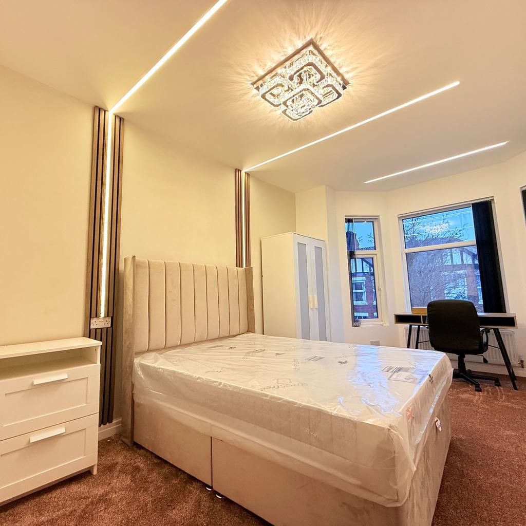 Bright, modern double bedroom with a plush upho...