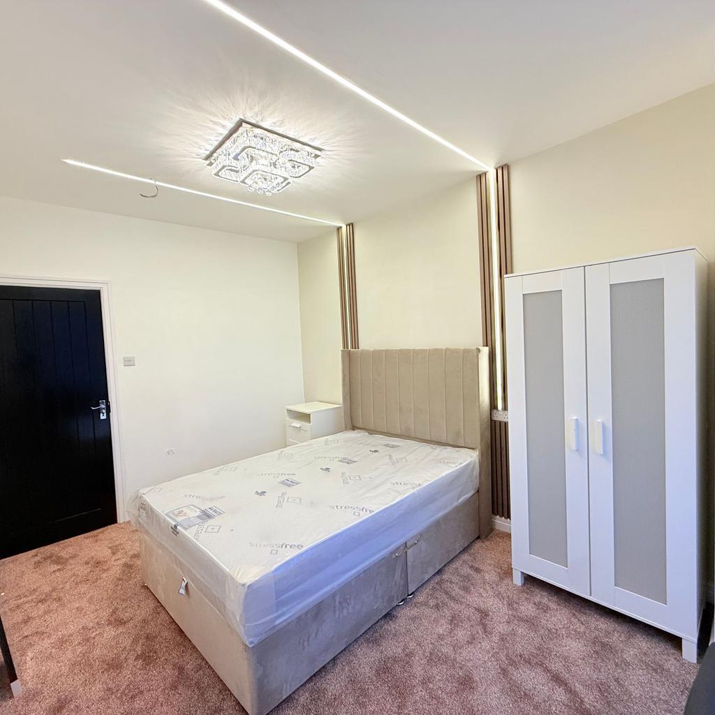 Bright, modern double bedroom with neutral tone...