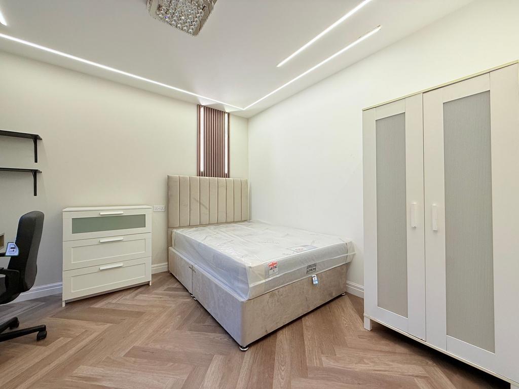 Bright, modern bedroom with a comfortable uphol...