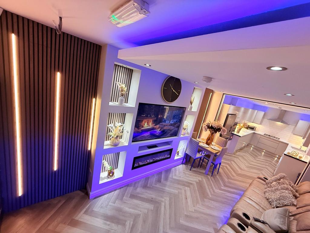 Stylish open-plan living area with built-in med...