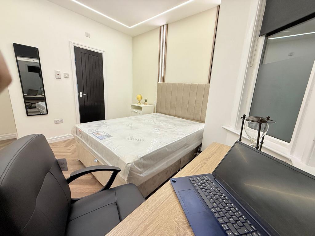 Bright, modern bedroom with a comfortable doubl...