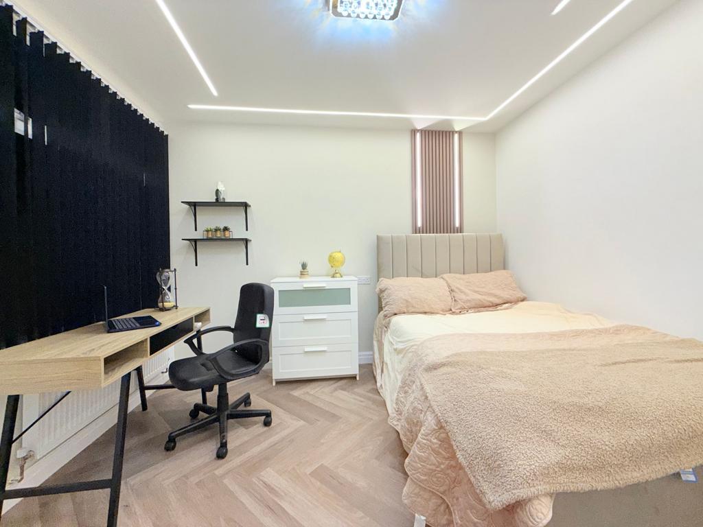 Bright, modern double bedroom with a comfortabl...