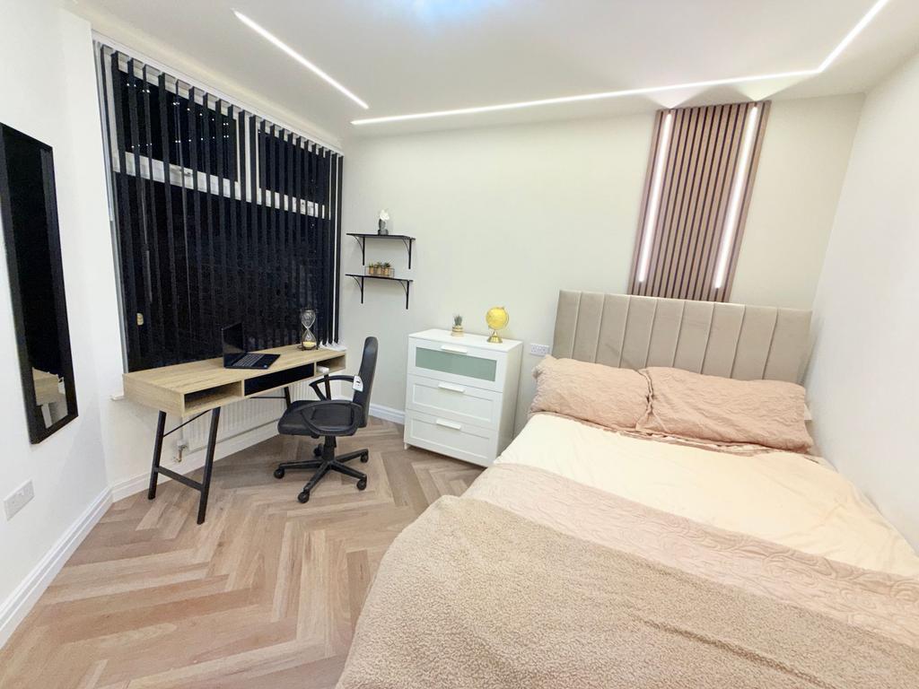 Bright, modern bedroom with a comfortable doubl...