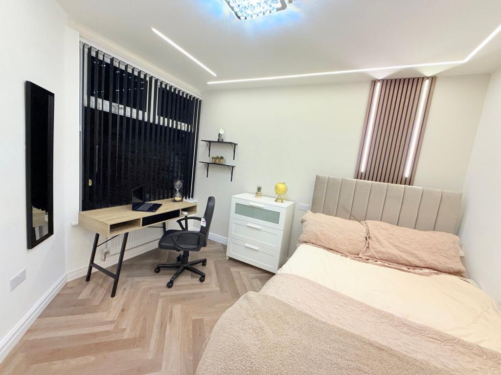 Bright, modern double bedroom with a comfortabl...