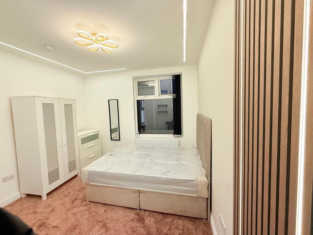 Bright, modern double bedroom with neutral deco...