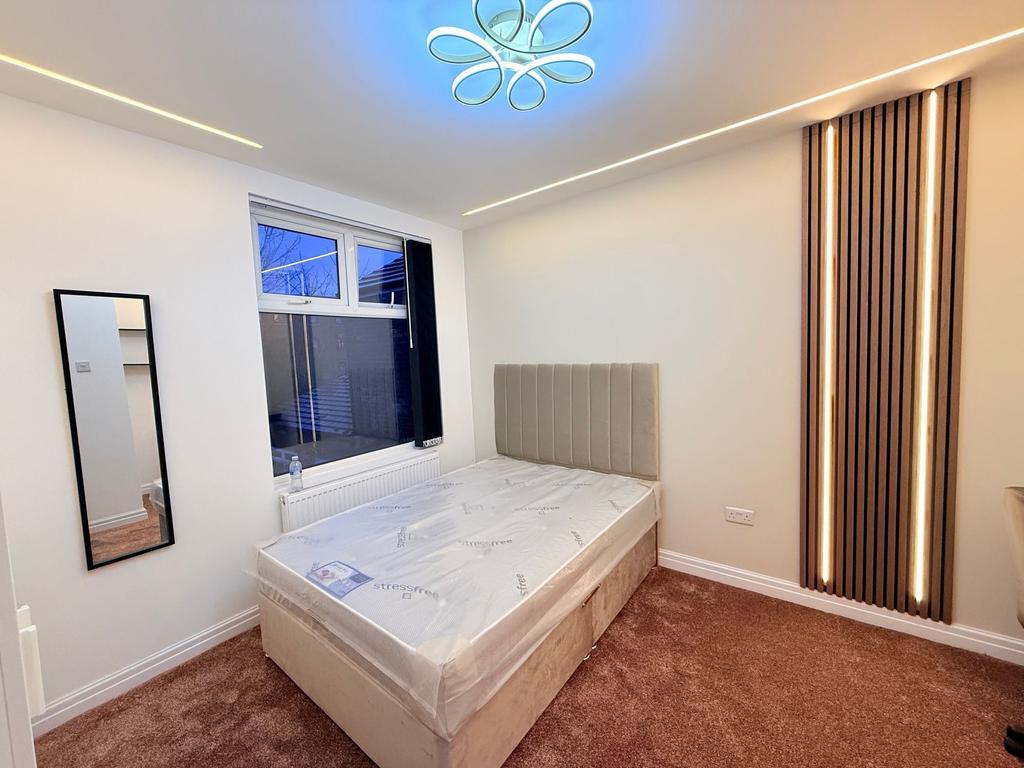 Bright, modern bedroom with a comfortable uphol...