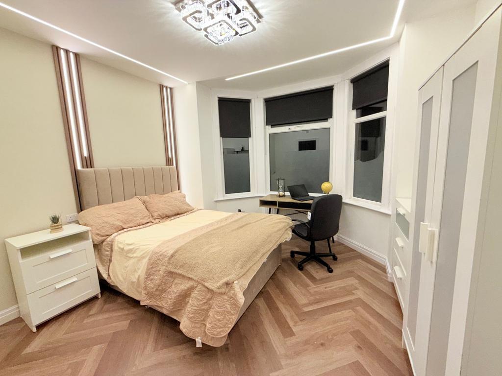 Bright, modern double bedroom with a comfortabl...