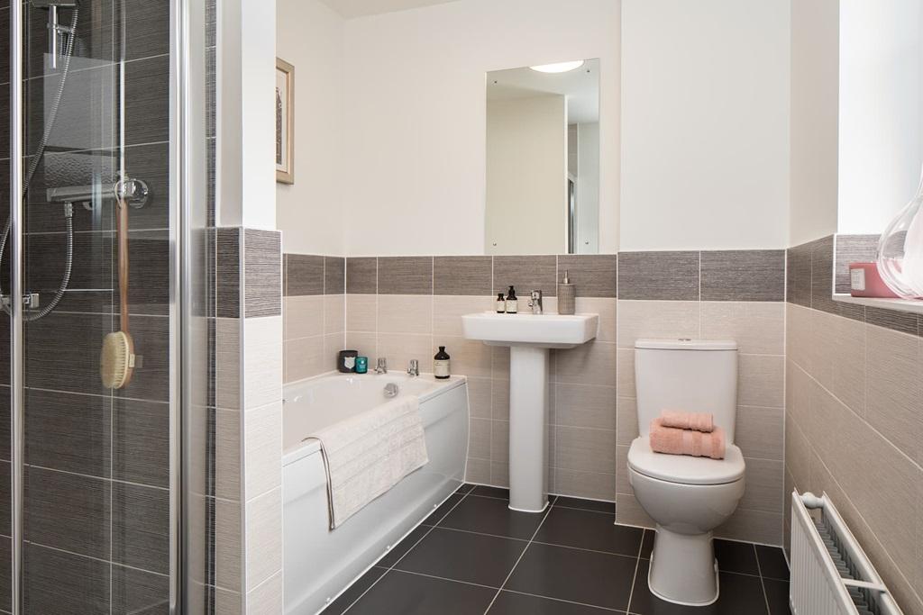Family friendly bathroom with separate bath and...