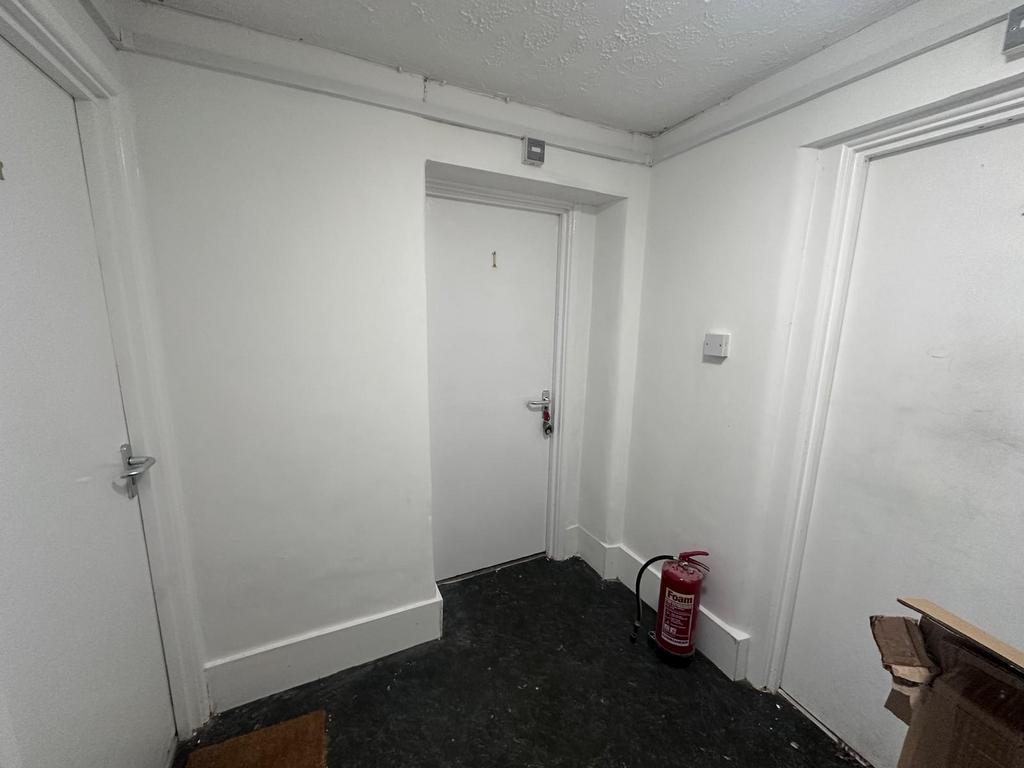 Well-maintained internal hallway with clean whi...