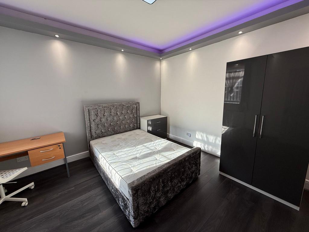 Bright, modern bedroom with a plush upholstered...