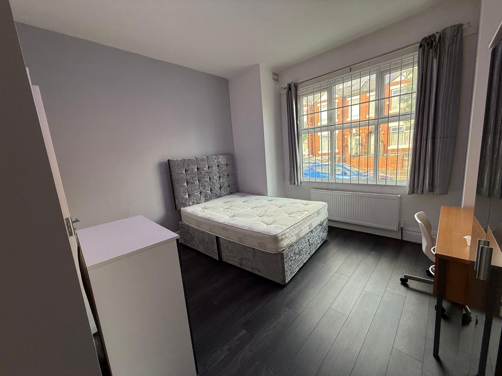 Bright, well-presented bedroom with a plush uph...