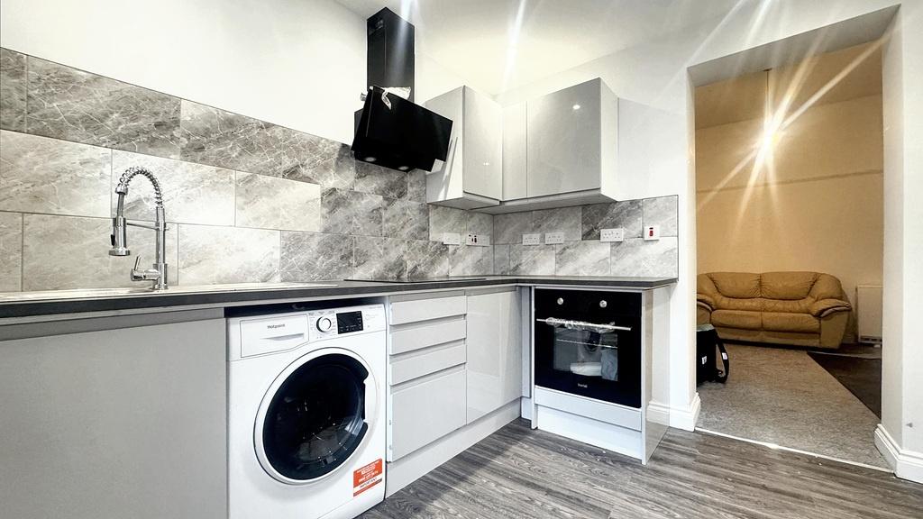 Bright modern kitchen with integrated oven, sle...