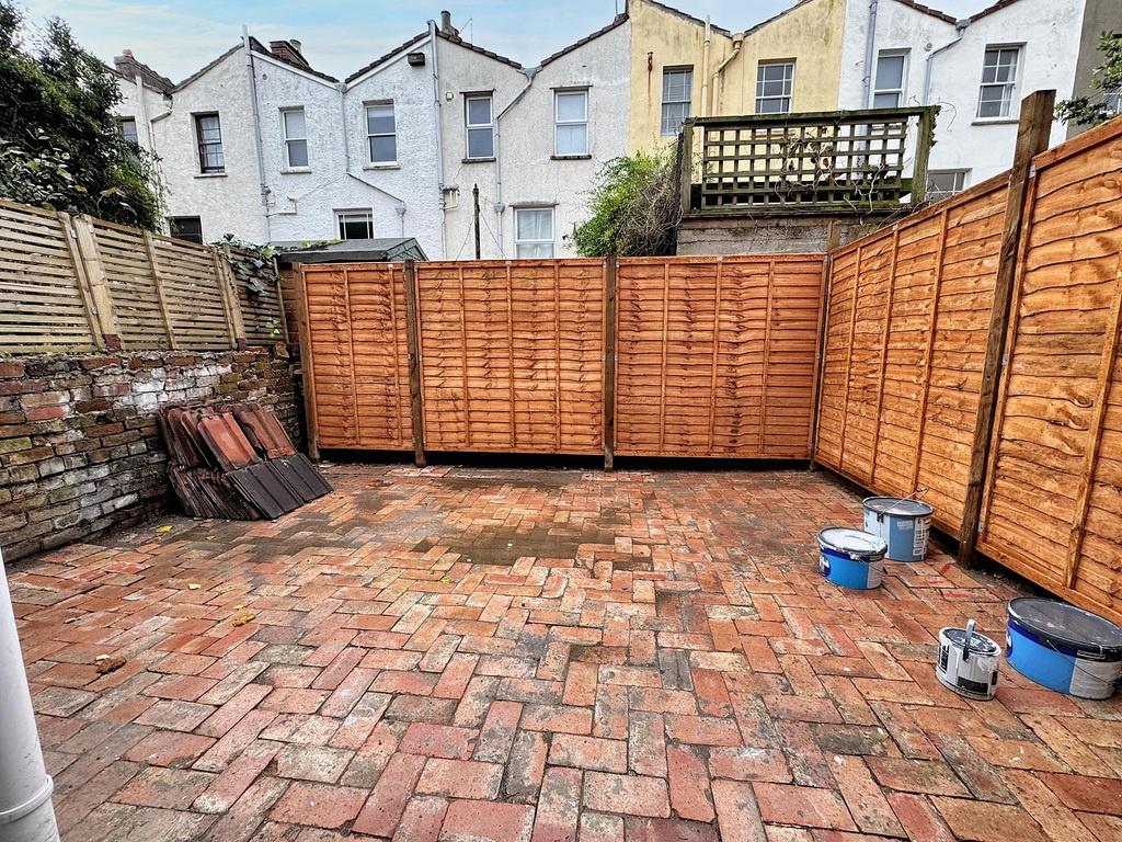 Private paved rear garden with newly fitted tim...