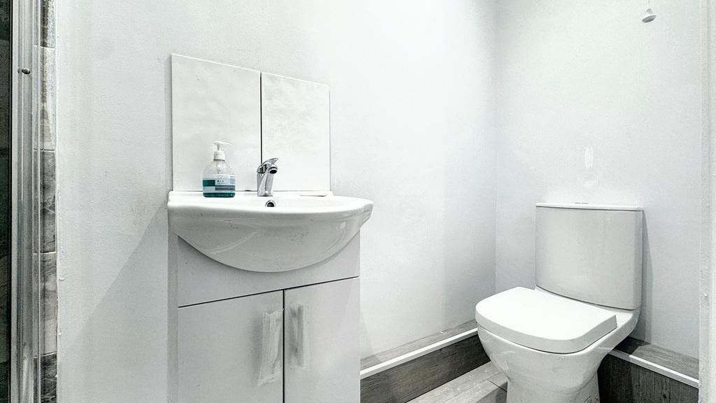 Bright, modern bathroom with a compact white va...