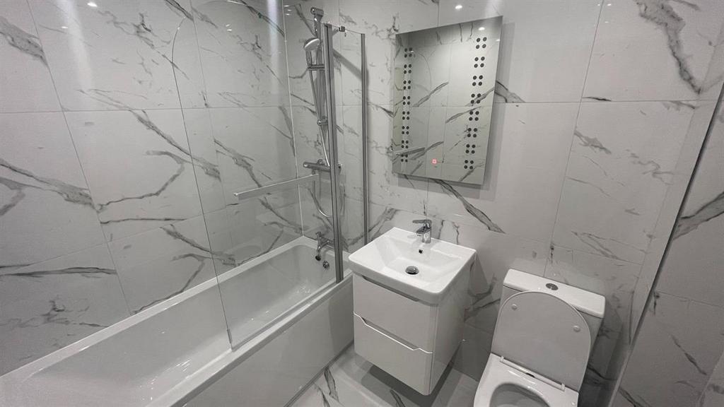 Contemporary bathroom with marble-effect wall t...
