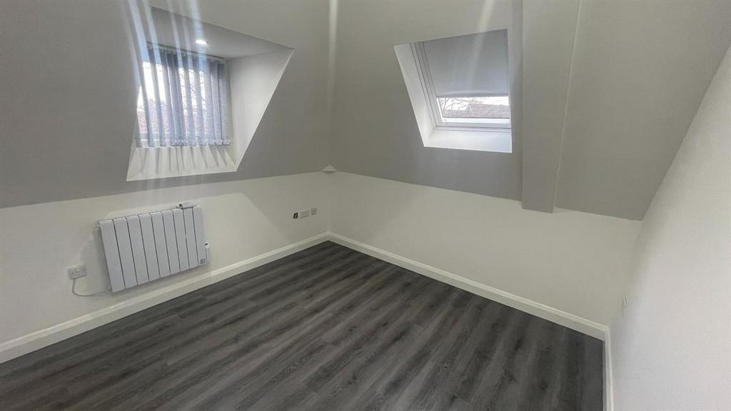 Bright attic bedroom with angled skylow windows...