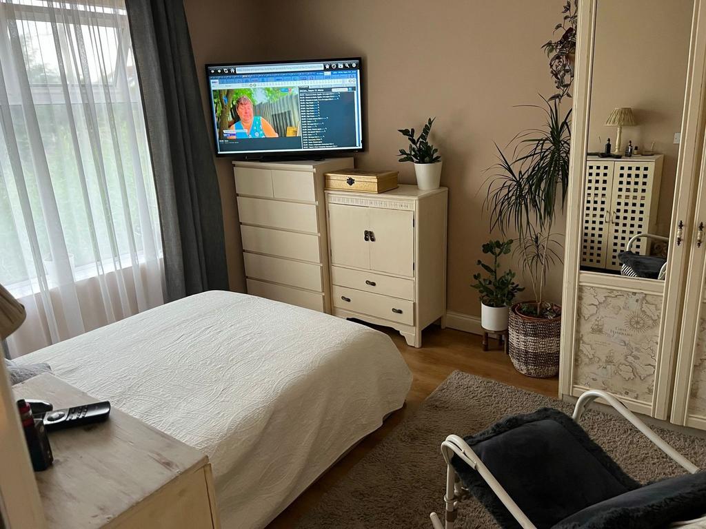 Bright, well-styled bedroom with large window l...