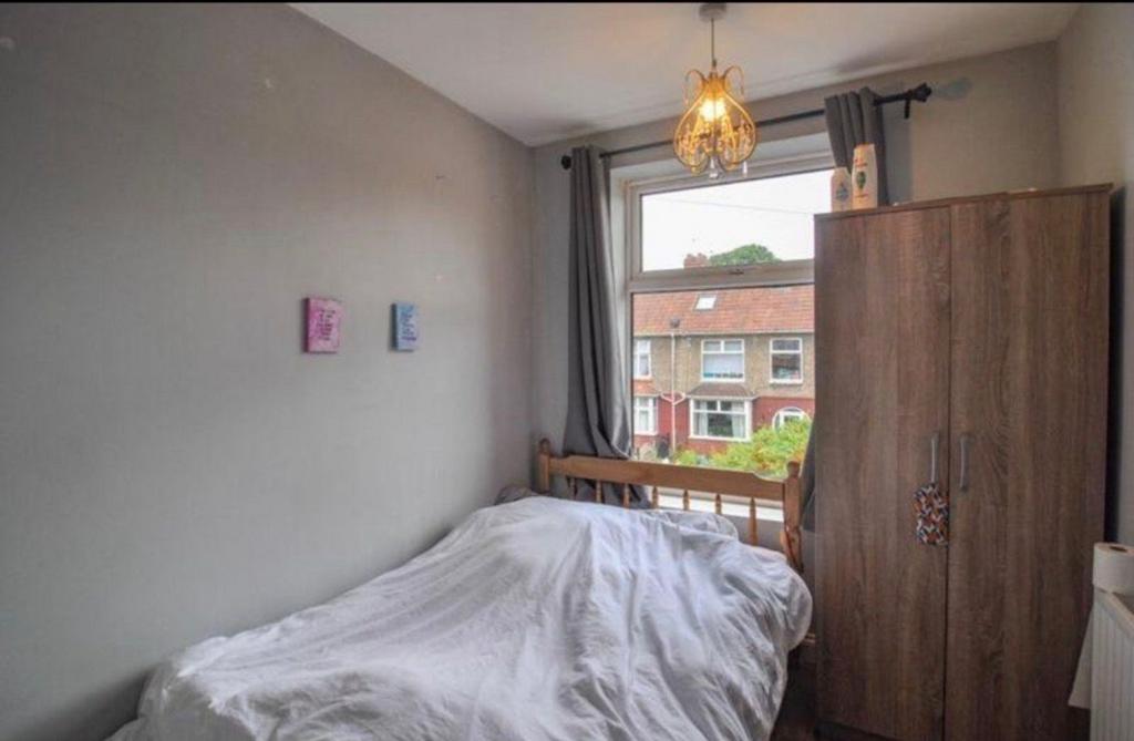 Cosy bedroom with a large window offering stree...