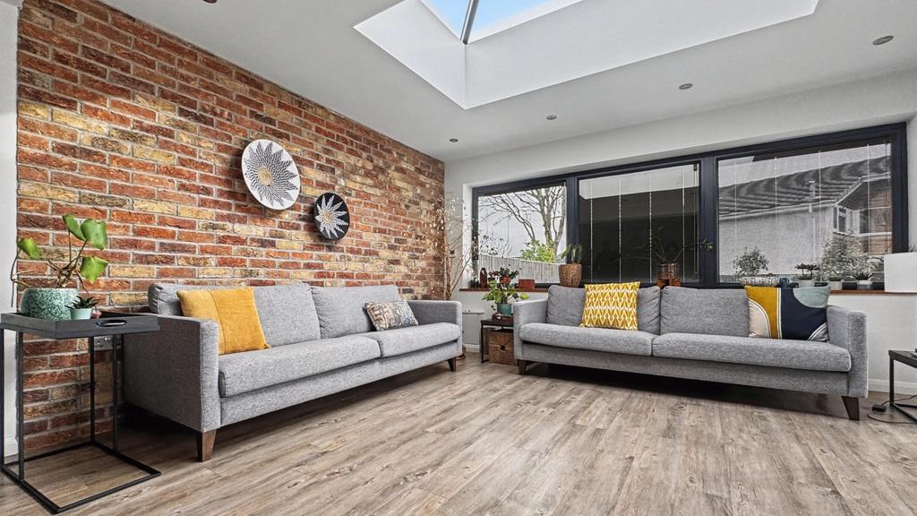 Bright, contemporary living room with exposed b...