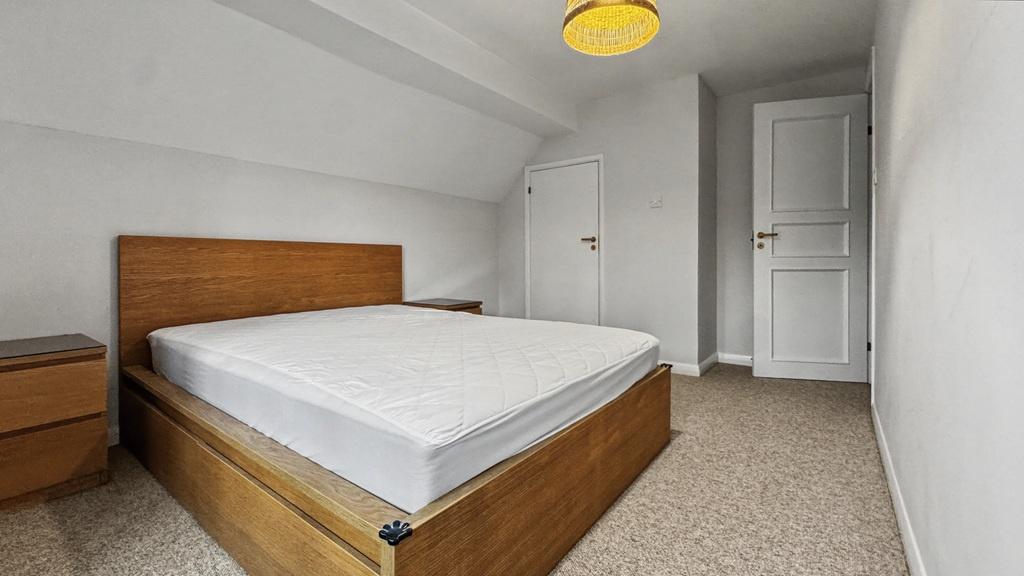 Bright, simply furnished double bedroom with a ...