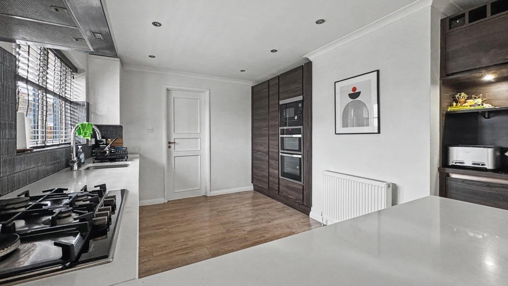 Bright modern kitchen with sleek white countert...