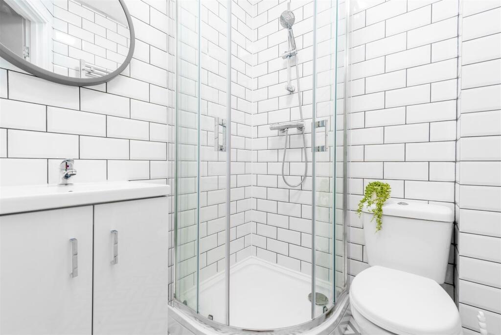Bright, modern bathroom with white subway tiles...