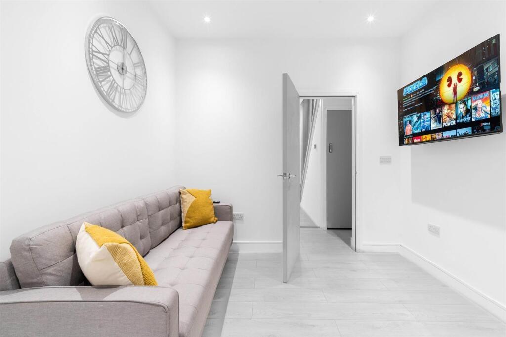 Bright, modern lounge with a comfortable grey s...