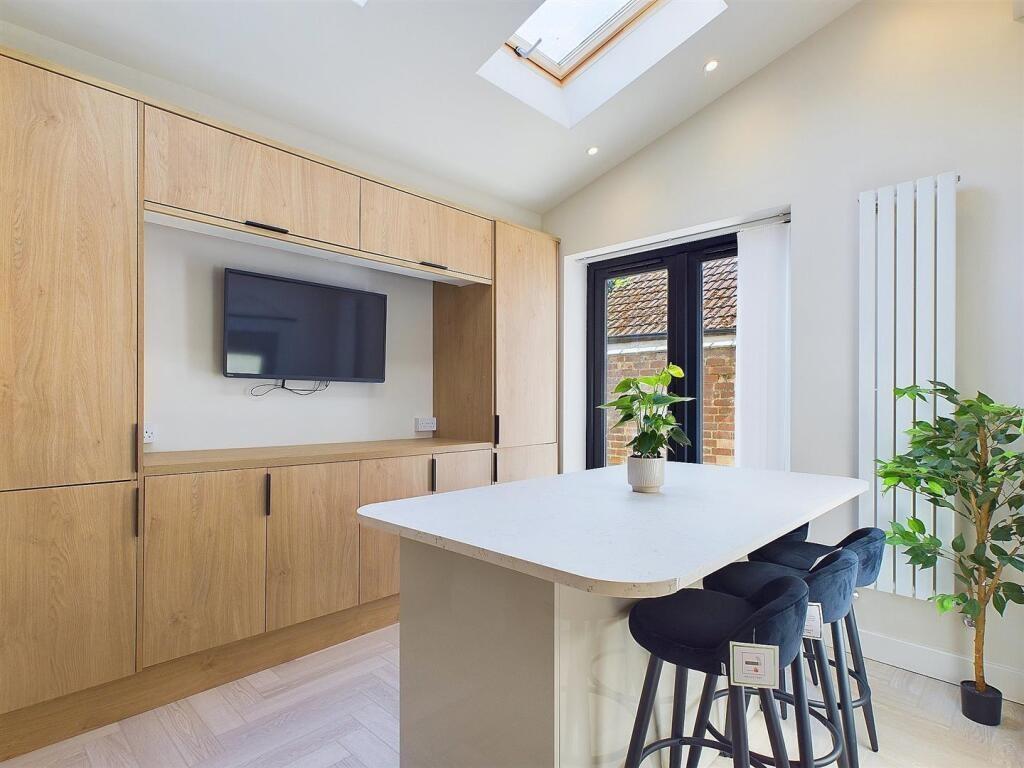 Bright modern kitchen with a central breakfast ...
