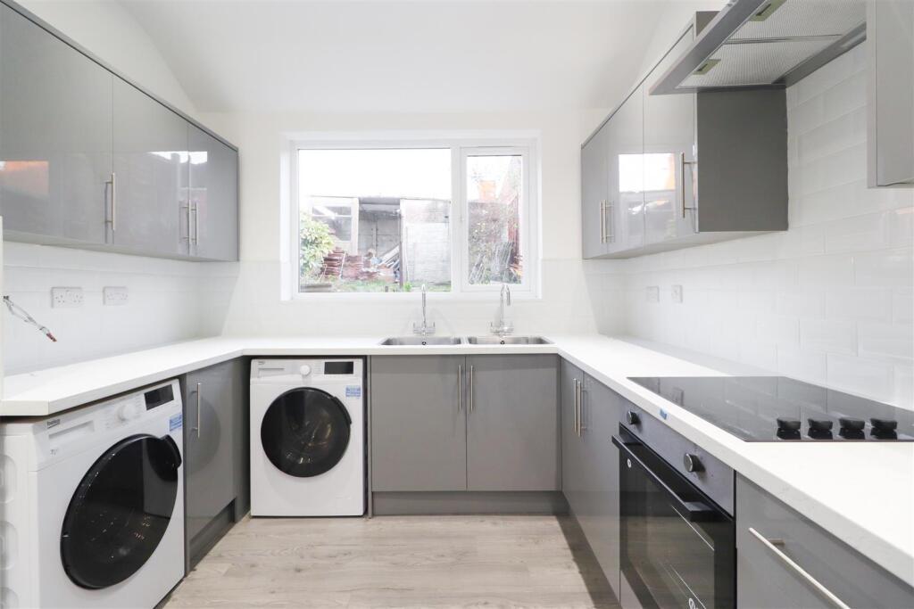 Bright, modern kitchen with sleek grey cabinets...