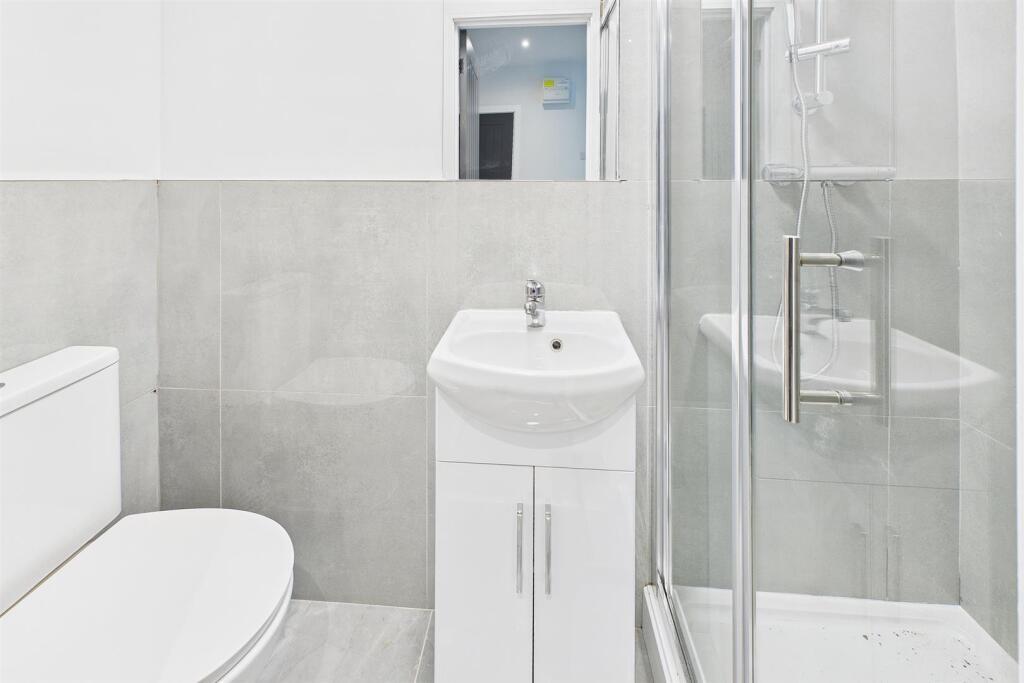 Bright, modern bathroom with a clean white vani...