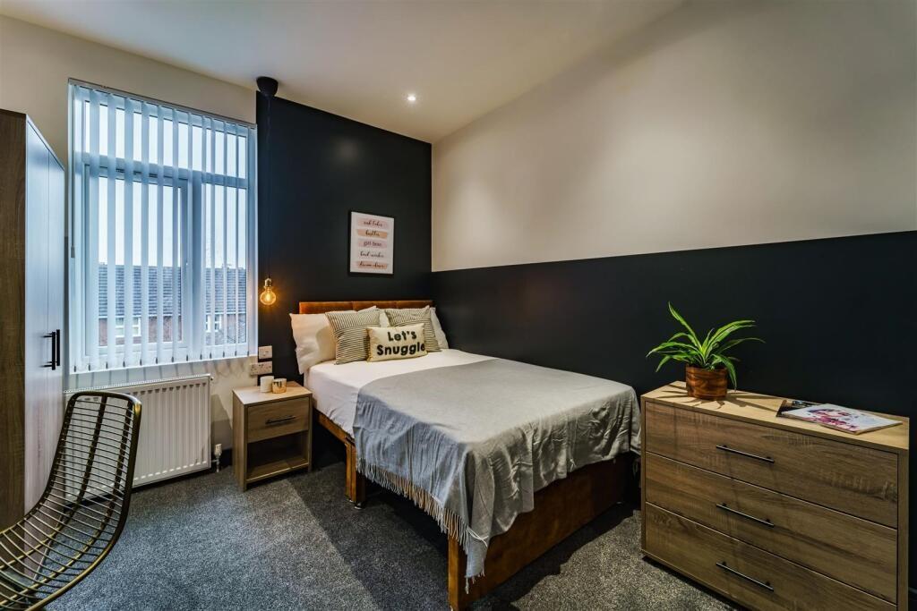 Well-presented double bedroom with a made bed, ...
