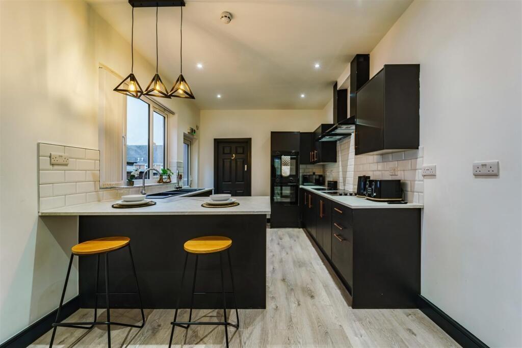 Contemporary kitchen with a central island, bre...
