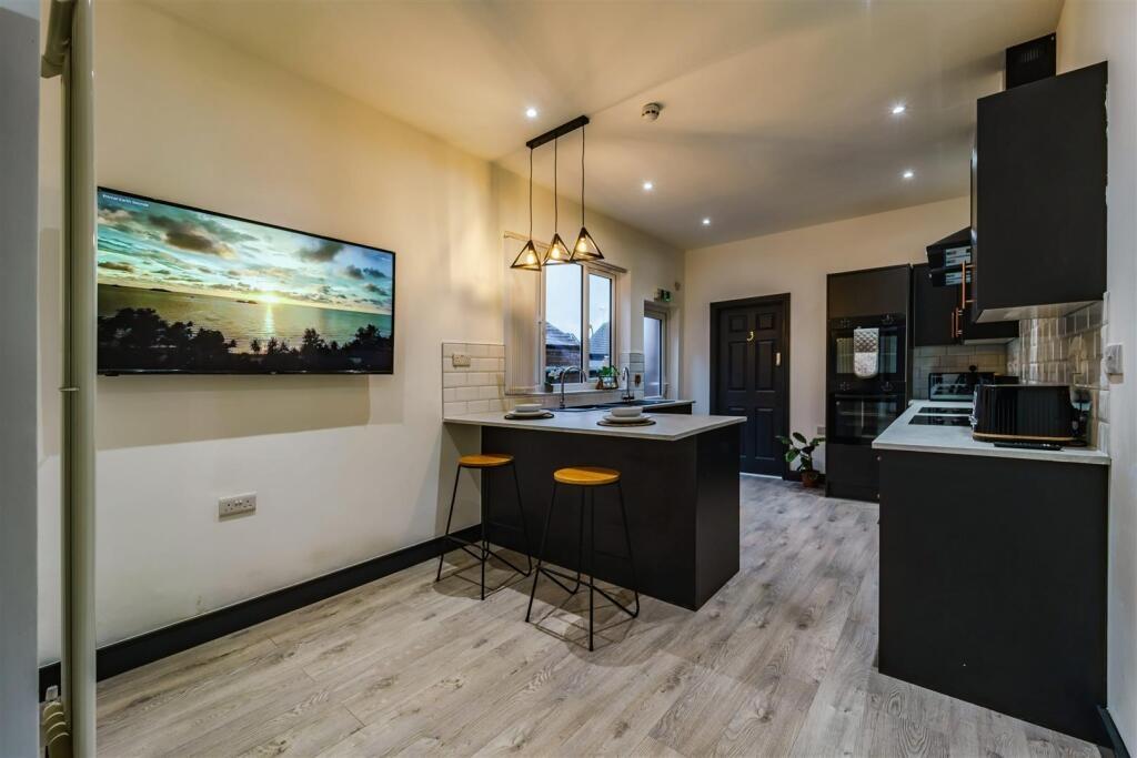 Modern open-plan kitchen with a central island,...