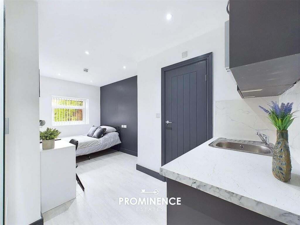 Bright, modern double bedroom with a clean whit...