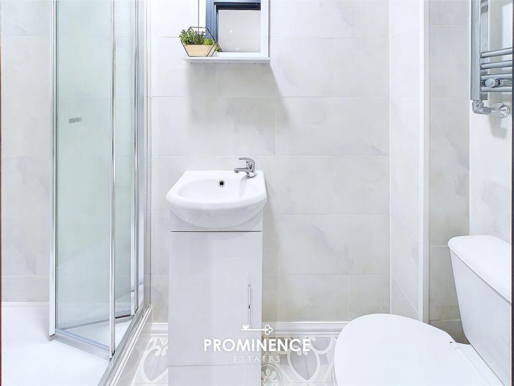 Bright, modern bathroom with a corner glass sho...