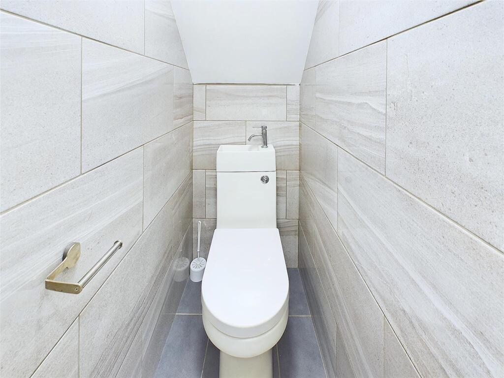 Bright, modern WC with clean white sanitaryware...