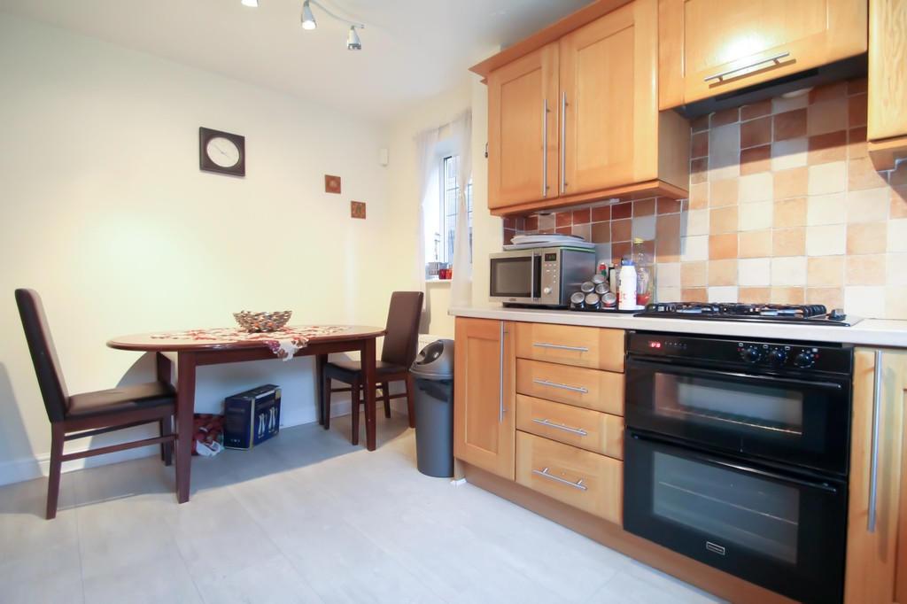 Bright, modern kitchen with warm wooden cabinet...