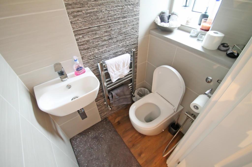 Neat, modern bathroom with a compact sink, cont...