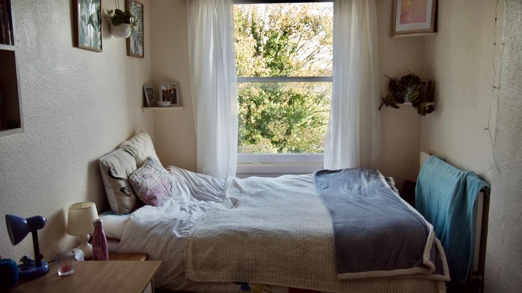 A bright and inviting double bedroom featuring ...