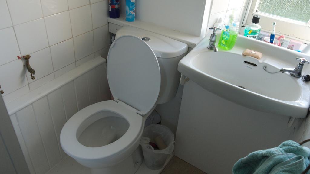 A bright and clean bathroom featuring a shower,...