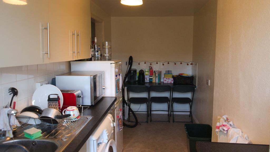A functional kitchen equipped with essential ap...
