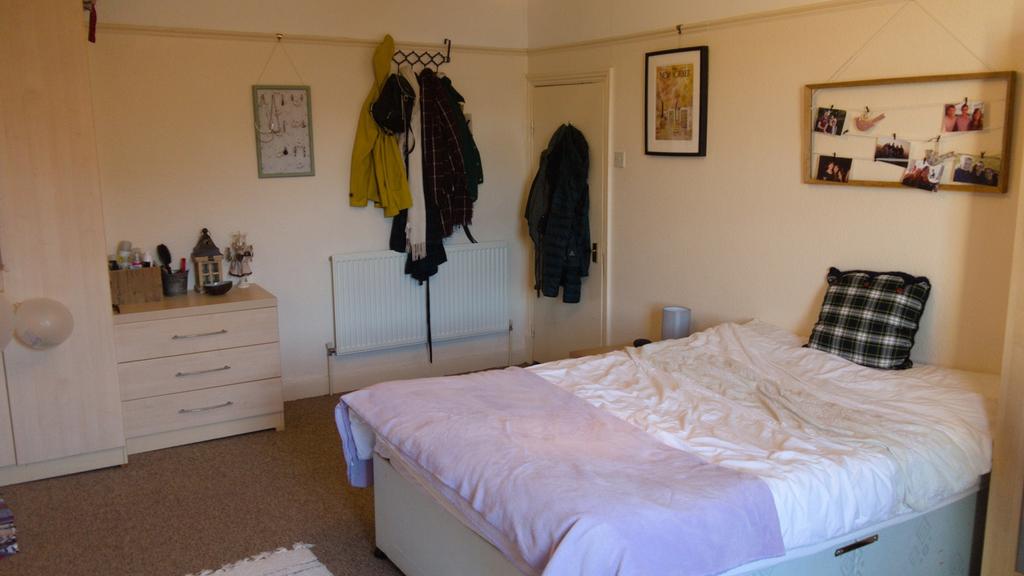 A spacious and inviting double bedroom featurin...