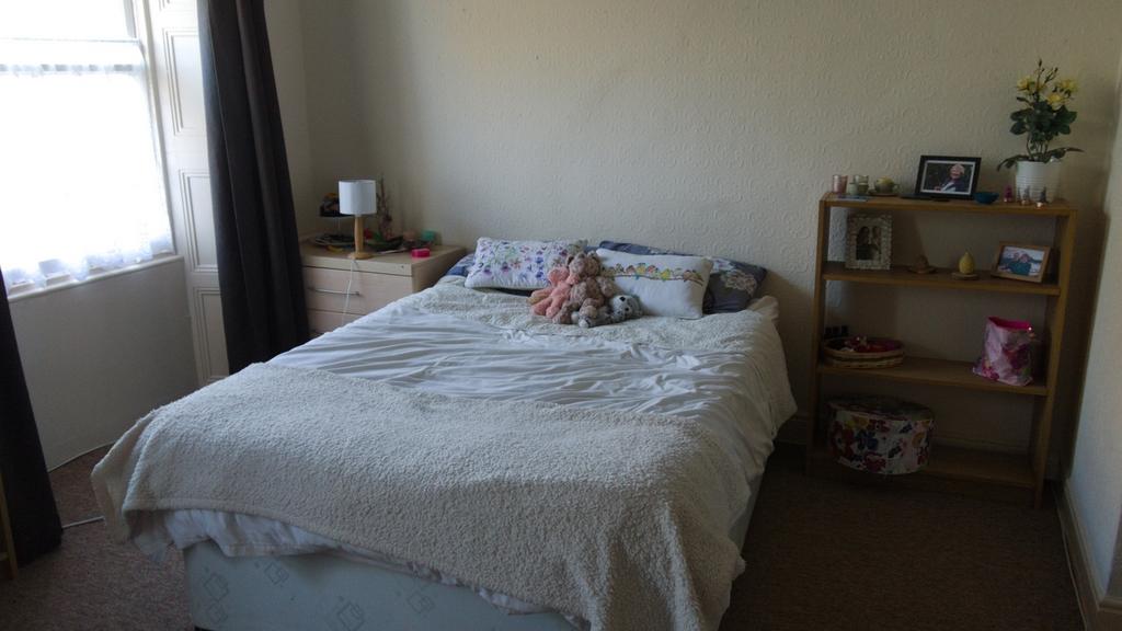 A cozy double bedroom with natural light and a ...