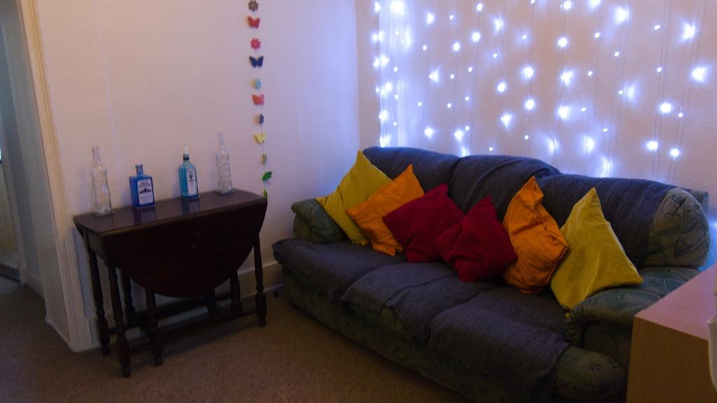 A cozy living room adorned with colorful pillow...