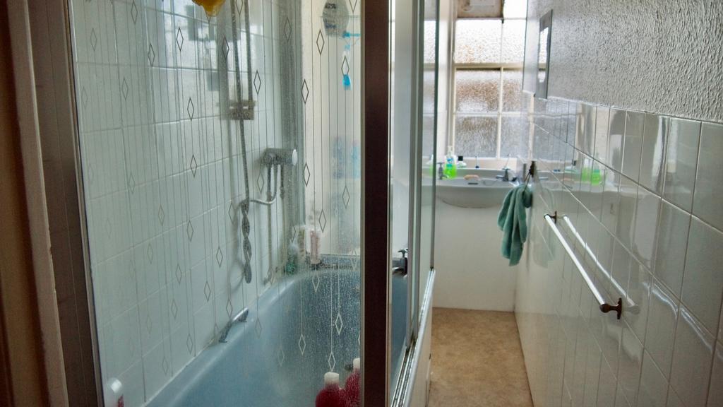 A functional bathroom featuring both a bath and...