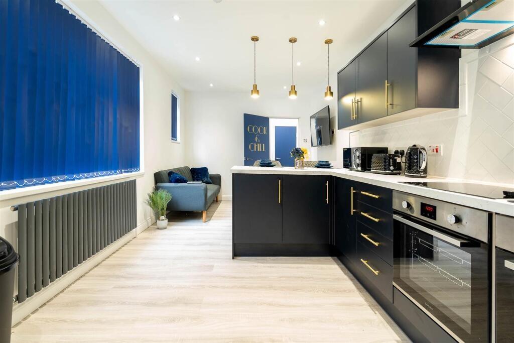 Bright modern kitchen with sleek black cabinets...