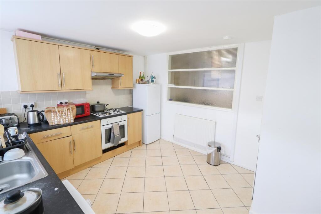 Bright, modern kitchen with light wood cabinets...
