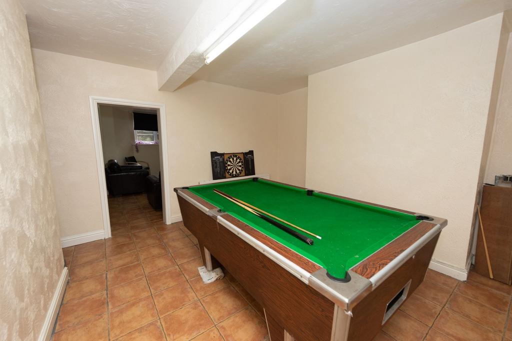 A cozy recreational room featuring a green felt...